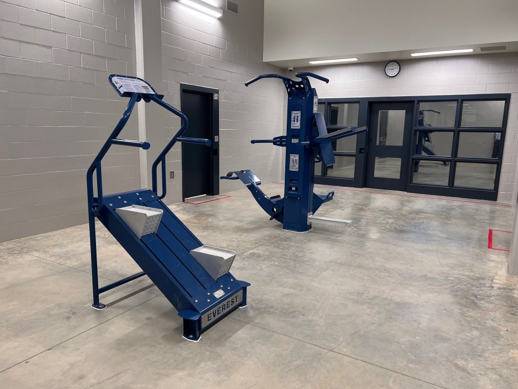 Correctional gym setup with tamperproof Outdoor-Fit machines.